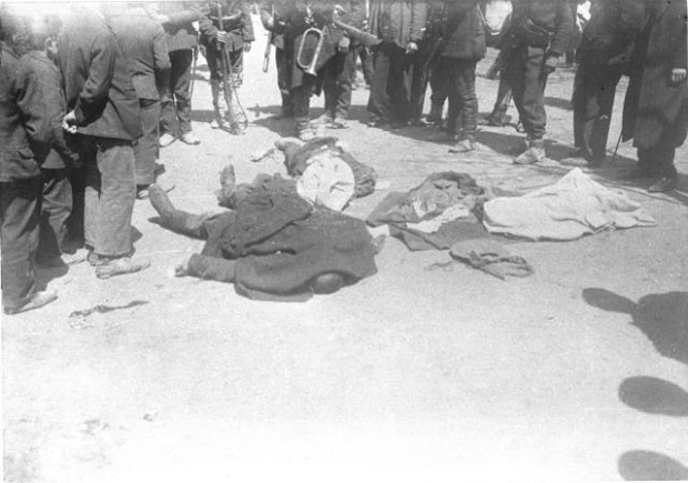 Istanbul (Constantinople) (April 1909) [Corpses covered with coats lying in street, surrounded by soldiers and Turks - victims of the April revolution by the Young Turks (Committee of Union and Progress) which resulted in the deposition of Sultan Abdulhamid II and the installation of a new Sultan - Mehmed V who was little more than a 'puppet' leader for the new regime] 